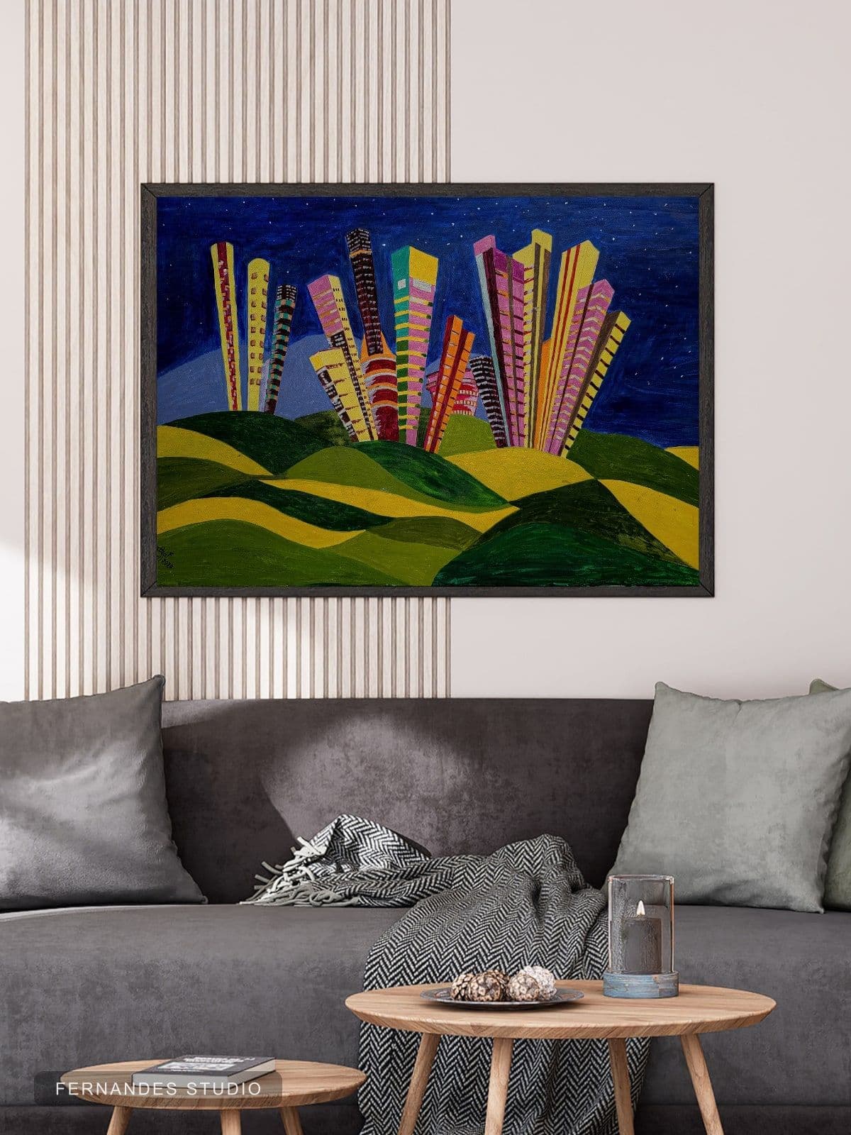 City of Dreams — tall colourful abstract towers rising from green hills under a starry night sky, framed on a gallery wall