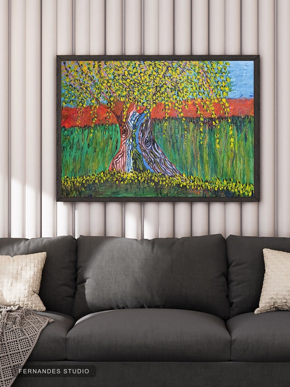 Tree of Colors — a stylized tree with multicolored bark against a green and red landscape, framed on a gallery wall
