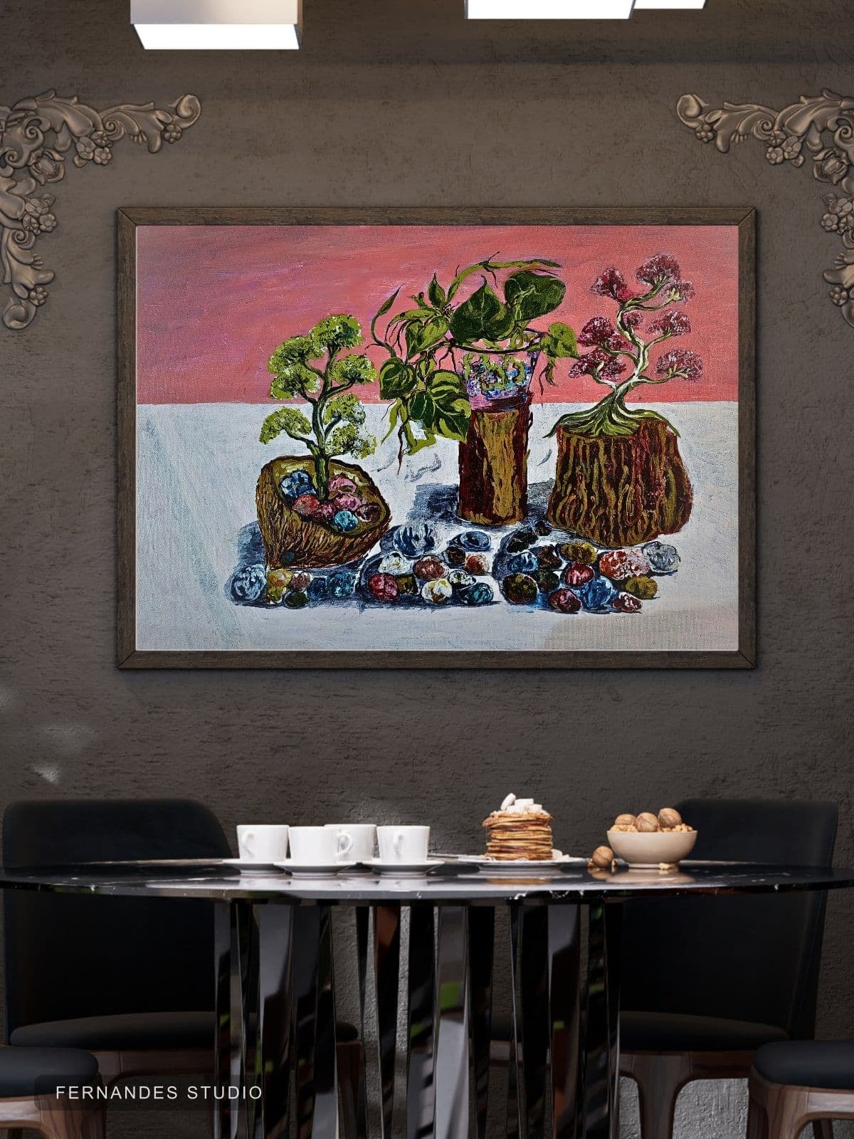 Still Life with Stones — three potted plants with colourful painted stones against a pink horizon, framed on a gallery wall