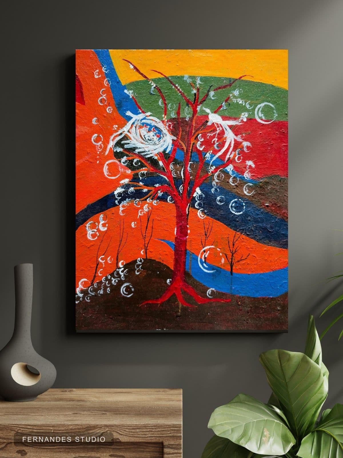 The Nesting Tree — a stylized red tree with a bird's nest against bands of vivid color, framed on a gallery wall